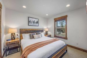 a bedroom with a large bed and a window at Suncadia 4 Bdrm Home with Private Hot Tub, Game room, Park view in Cle Elum +30 photos