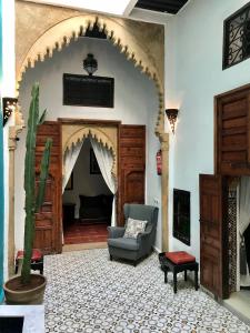 a living room with a chair and a couch at Riad Dar Souika in Rabat