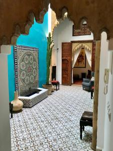 a living room with a tile floor and a fireplace at Riad Dar Souika in Rabat