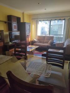 a living room with a couch and a table at AGARIMO APARTAMENTO in Pontevedra