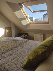 a bedroom with a bed with a large window at AGARIMO APARTAMENTO in Pontevedra