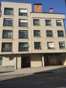 an apartment building on the side of a street at AGARIMO APARTAMENTO in Pontevedra