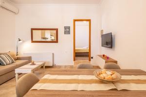 a living room with a couch and a table at House for two!! in Angairiá