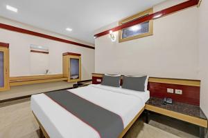 a bedroom with a large bed in a room at Collection O Sri Sai Ram Suites in Bangalore