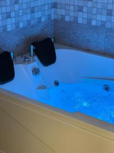 a bath tub with blue water in a bathroom at شقق ضيف بارك للشقق المخدومة in Ad Dawādimī