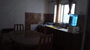 a kitchen with a table and a sink and a window at Diamantito in Gualeguaychú
