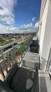 a balcony with chairs and a table on a balcony at Grand F2 dernier etage belle vue in Le Blanc-Mesnil