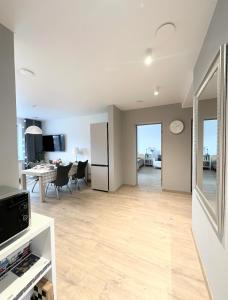 a living room with a refrigerator and a table at Miegu - Apartments in Druskininkai