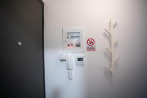 a white wall with a phone on it at Plateia Pargis Apartment I in Ioannina
