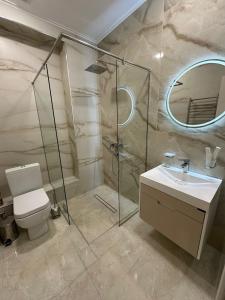 a bathroom with a shower and a toilet and a sink at Lux Plaza (New Rooms) in Pʼarakʼar