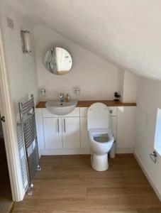 a bathroom with a toilet and a sink at Trelowen Cottage in Callington