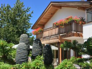 Casa con balcón con plantas y árboles en Chalet Ly's Nest, en Aldino