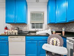 a blue kitchen with blue cabinets and a dishwasher at 3 Bedroom Hot Tub w/ Private Movie Theater in Basye