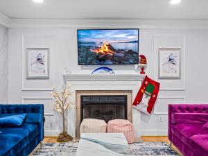 a living room with a fireplace with a tv on the wall at 3 Bedroom Hot Tub w/ Private Movie Theater in Basye