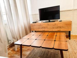 a living room with a tv and a wooden table at Traditional House Old Town Xanthi - MenoHomes 3 in Xanthi
