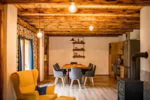 a dining room with a table and chairs at Na samotě u lesa - Jeseníky in Mikulovice