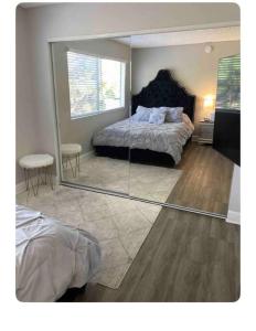 a bedroom with a bed and a large mirror at Gorgeous 1 bedroom Beverly Hills in Los Angeles