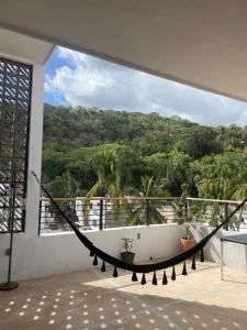 een hangmat op een balkon met uitzicht bij Penthouse kavali in Los Ayala