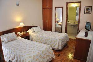 Postel nebo postele na pokoji v ubytování Hotel Los Cedros