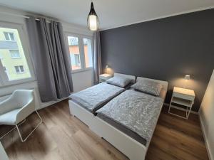 a bedroom with a bed and a large window at Aus alt wird neu - Apartment in Essener City in Essen