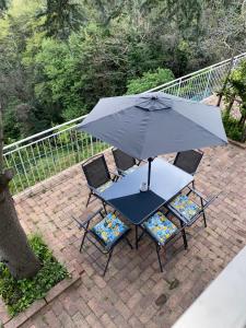 a table and chairs with an umbrella on a patio at La Perla del Mare Apartment Vietri sul Mare in Albori +23 photos