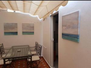 a dining room with a table and chairs at 1 linea playa Islantilla in Islantilla
