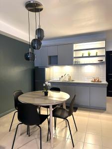 a kitchen with a table and chairs in a room at CRIB 217 SUBIC BAY - Modern Fresh Condo in Olongapo