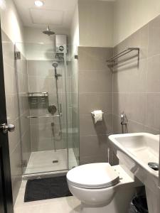 a bathroom with a shower and a toilet and a sink at CRIB 217 SUBIC BAY - Mediterranean Condo with Unlimited Massage in Olongapo