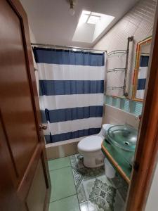 a bathroom with a toilet and a shower at Casa Gabriel in Antigua Guatemala