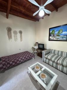 sala de estar con sofá y ventilador de techo en Cabañas Autodromo en Termas de Río Hondo