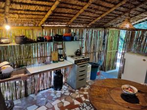 a kitchen with a counter and a stove and a table at Rumi Wilco Ecolodge & Nature Reserve in Vilcabamba