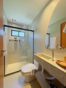 a bathroom with a shower and a toilet and a sink at Casa Salga Patacho F003 - Rota Ecológica de São Miguel dos Milagres in Pôrto de Pedras