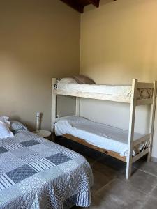 a bedroom with two bunk beds in a room at Cabañas Autodromo in Termas de Río Hondo