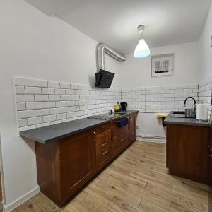 a kitchen with a sink and a counter top at Apartament Tuwima 1 in Prudnik