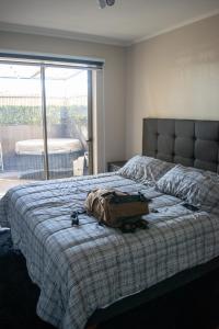 a bedroom with a bed with a backpack on it at Calama: Tranquilidad Urbana in Calama