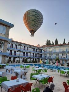 a hot air balloon is flying over a pool at Uyum Hotel in Pamukkale