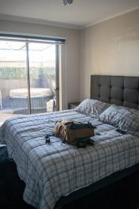 ein Schlafzimmer mit einem Bett mit einer Tasche darauf in der Unterkunft Calama: Tranquilidad Urbana in Calama