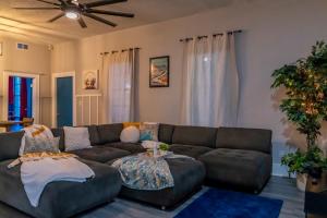 a living room with a couch and a table at 5Beds-Walk to Bars and Shops-On Free Trolley Route in Tampa