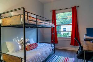a bedroom with two bunk beds and a window at 5Beds-Walk to Bars and Shops-On Free Trolley Route in Tampa