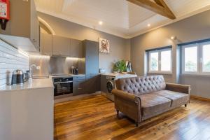 a living room with a couch in a kitchen at Canto do Atlântico Loft (City Centre) in Ponta Delgada