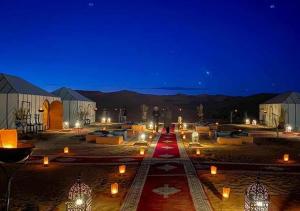 a group of candles in a courtyard at night at Shiny luxury camp in Merzouga