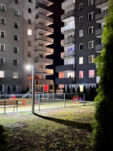a playground in front of a apartment building at night at Apartament Przy Obserwatorium&Singielnia in Olsztyn