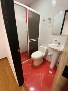 a bathroom with a toilet and a sink at HOTEL Y RESTAURANTE SHALOM in Pamplona