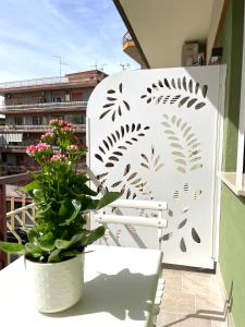 a white fence with a plant on a balcony at COLOMBO SUITE in Cassino