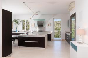 a kitchen with a sink and a counter top at VILLA PHILIPPA - luxurious five-room villa on the island of BRAČ - idyllic location right by the sea - incredible view of the sea bay - VIP services - BURALUX properties in Sutivan