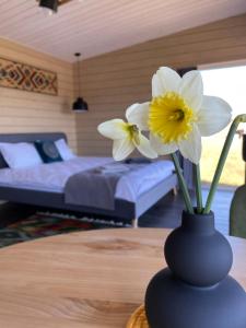 a blue vase with two white flowers on a table at DIDO house in Slavske