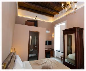 a bedroom with a bed and a mirror at Xenia Neapolis in Naples