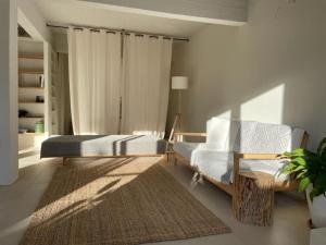 a living room with a bed and a couch and a rug at Casa Massina in Áno Poróïa
