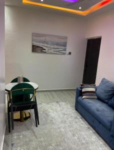 a living room with a couch and a table at Cosy Apartment - East Legon - Adjiringanor in Ogbojo