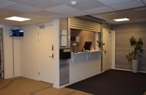 an office cubicle with a counter and a desk at Hostel Snoozemore in Gothenburg